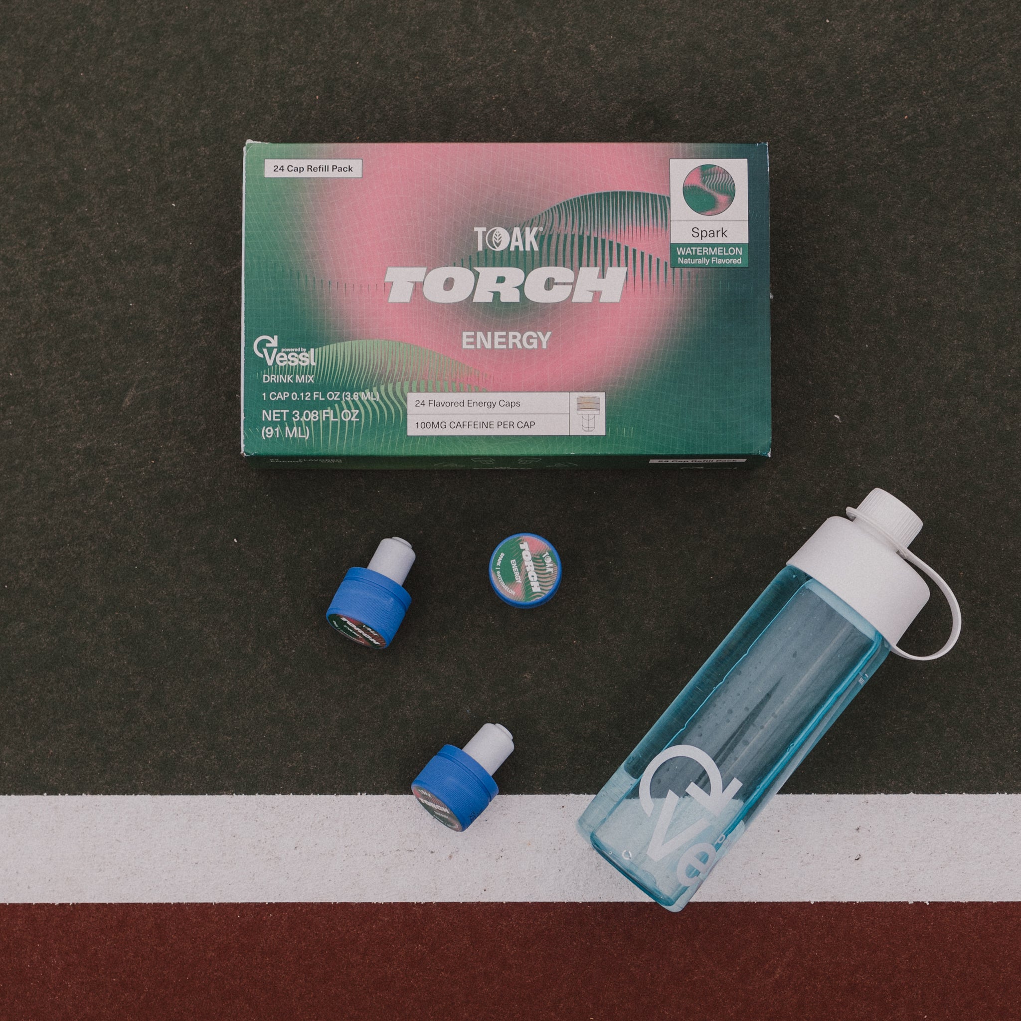 TOAKTorch energy drink mix packaging with a blue and white bottle on a dark surface.